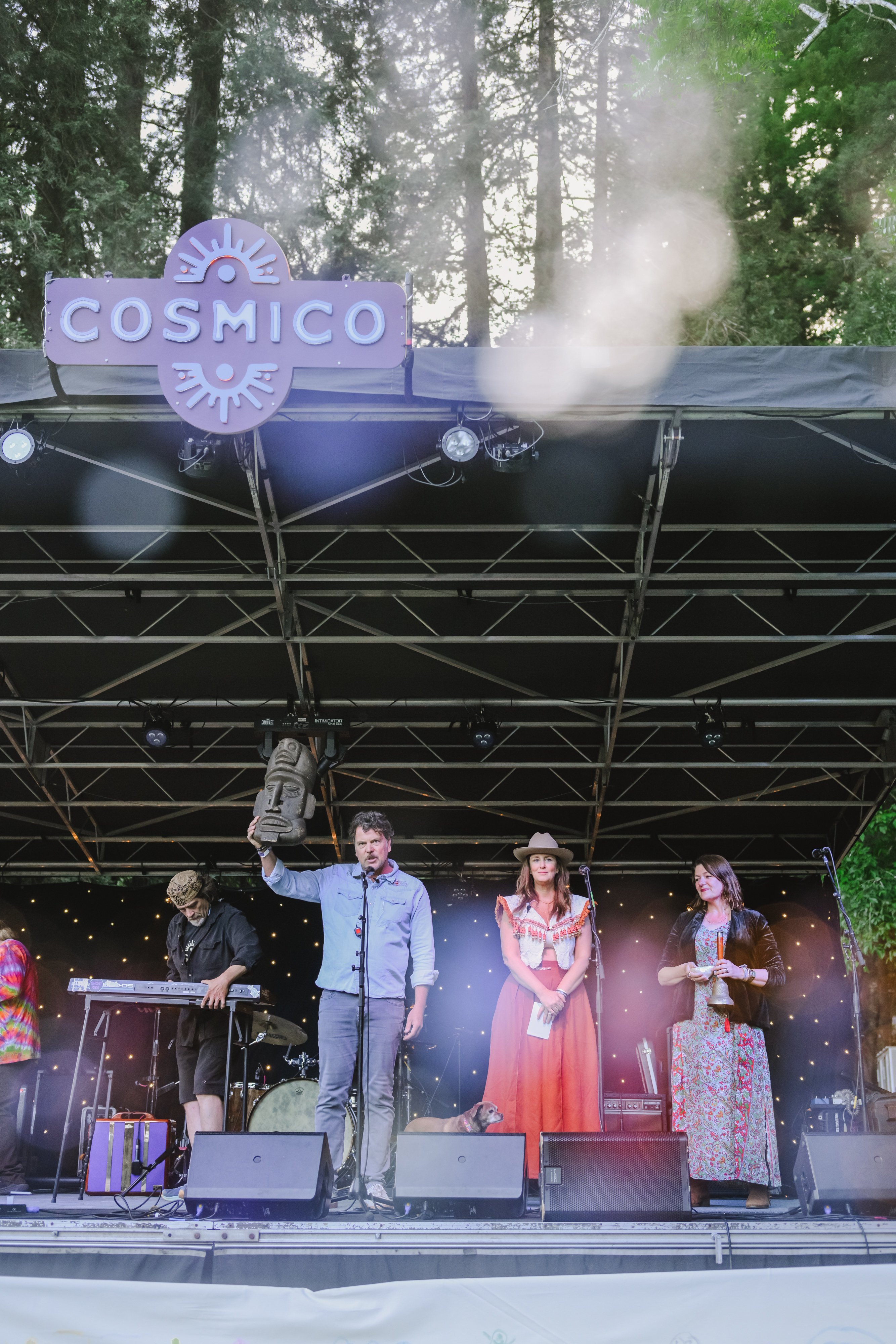 Chris and Anne onstage with other performers and a dog at Cosmico
